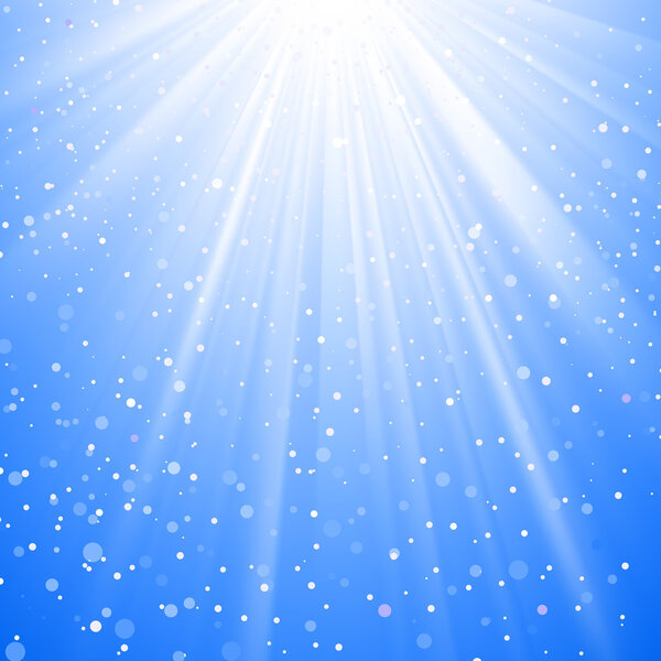 Shining sunbeams from above with snow flakes