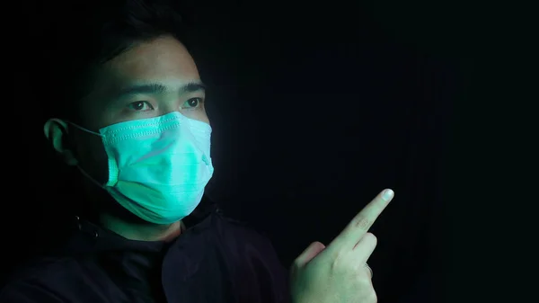 Asian man wearing protective mask isolated over background