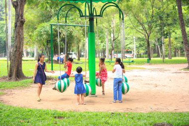 Hochiminh City, Vietnam - July 8, 2015: Children playing in the park carousel in a park in the center of HoChiMinh city