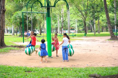 Hochiminh City, Vietnam - July 8, 2015: Children playing in the park carousel in a park in the center of HoChiMinh city