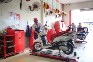 Hochiminh City, Vietnam - June 23, 2015: professional motorcycle repairman at a service center of Honda motorcycles in Ho Chi Minh City, Vietnam