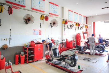 Hochiminh City, Vietnam - June 23, 2015: professional motorcycle repairman at a service center of Honda motorcycles in Ho Chi Minh City, Vietnam