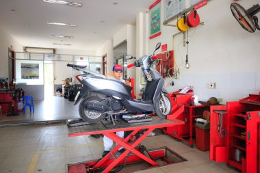 Hochiminh City, Vietnam - June 23, 2015: professional motorcycle repairman at a service center of Honda motorcycles in Ho Chi Minh City, Vietnam