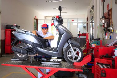 Hochiminh City, Vietnam - June 23, 2015: professional motorcycle repairman at a service center of Honda motorcycles in Ho Chi Minh City, Vietnam