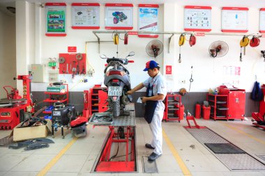 Hochiminh City, Vietnam - June 23, 2015: professional motorcycle repairman at a service center of Honda motorcycles in Ho Chi Minh City, Vietnam