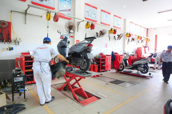 Hochiminh City, Vietnam - June 23, 2015: professional motorcycle repairman at a service center of Honda motorcycles in Ho Chi Minh City, Vietnam