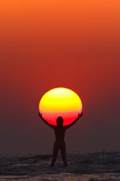 woman seems to hold the sun