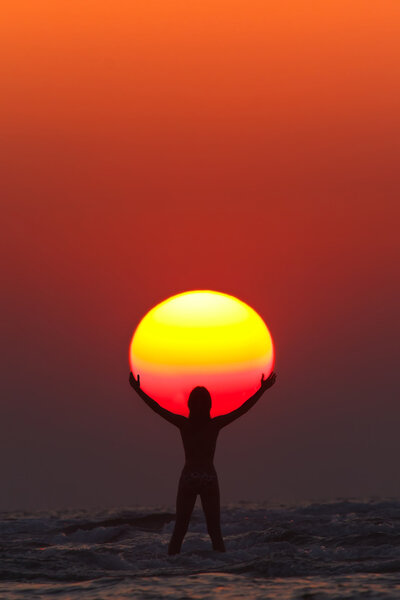 woman seems to hold the sun