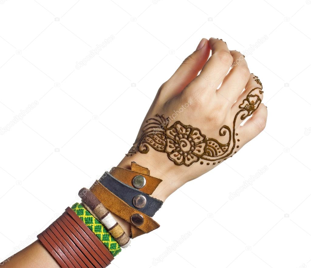 Mehendi or henna tatoo on the female hands in bracelets isolated