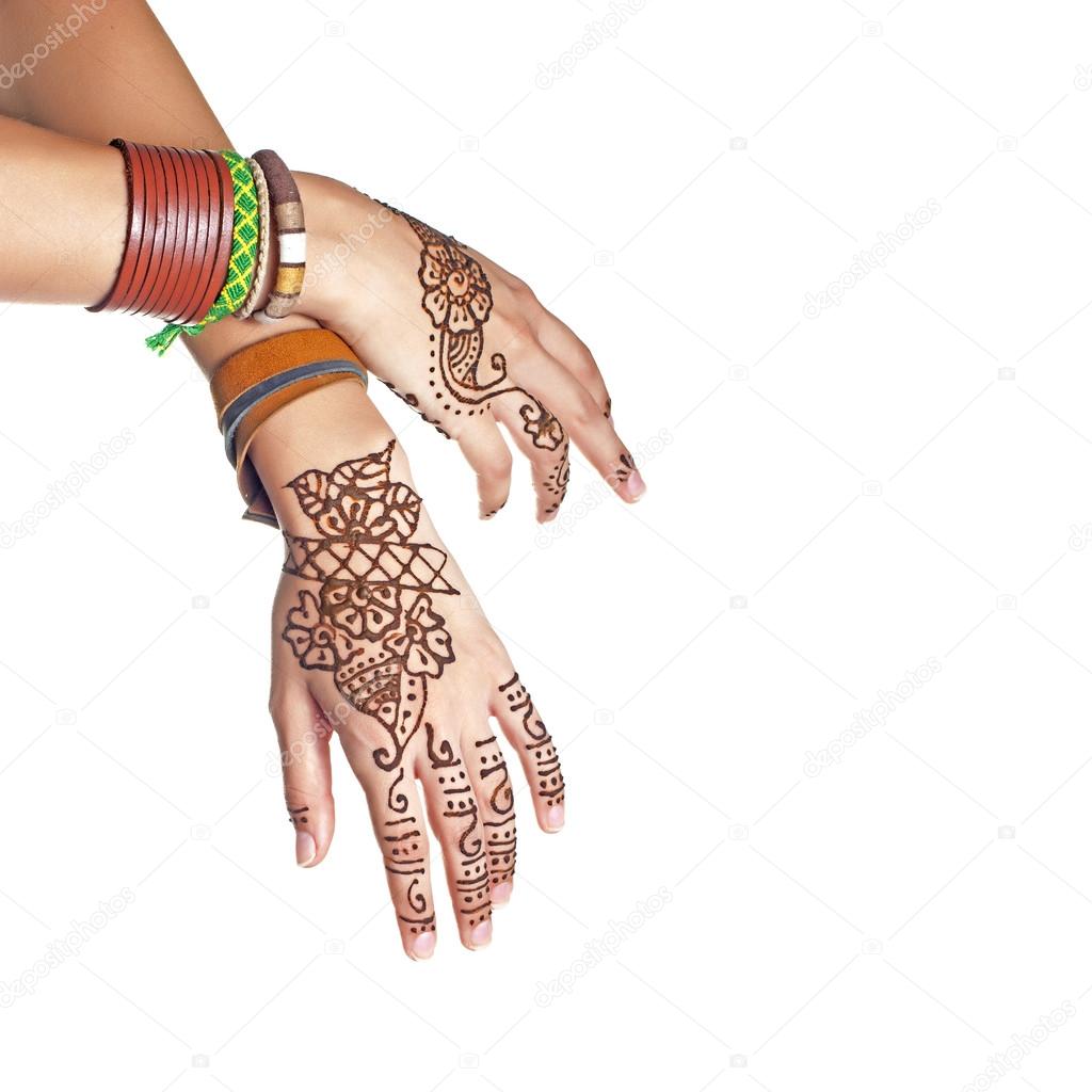 Mehendi or henna tatoo on the female hands in bracelets isolated