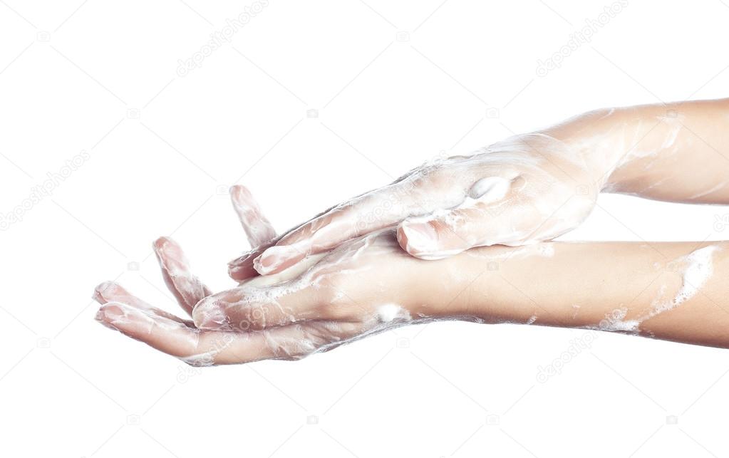 Woman washes her hands. pictured female hands in soapsuds. Isolated on white
