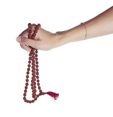 Rudraksha rosary in a female hand. Japa mala clipart