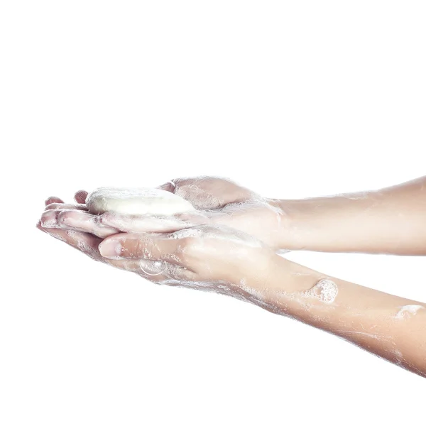 Vrouw wast haar handen in onschuld. afgebeeld vrouwelijke handen in sopje. Geïsoleerd op wit — Stockfoto
