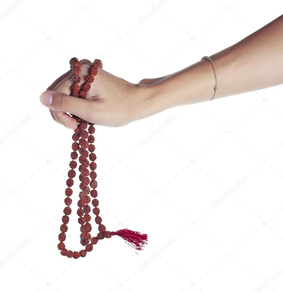Rudraksha rosary in a female hand. Japa mala Stock Photo by