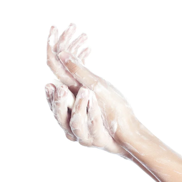 La mujer se lava las manos. las manos femeninas en jabones. Aislado sobre blanco Fotos de stock