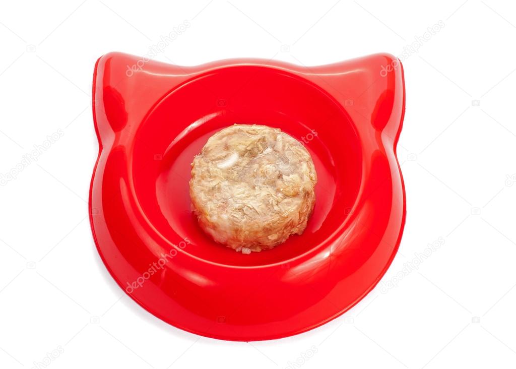 Cat wet food in a red bowl isolated on white.