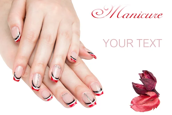 Franse manicure - mooie verzorgde vrouw handen met rode en zwarte manicure met strass geïsoleerd op witte achtergrond — Stockfoto