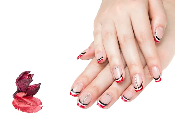 Manicura francesa - hermosas manos femeninas cuidadas con manicura roja en blanco y negro con pedrería aislada sobre fondo blanco — Foto de Stock
