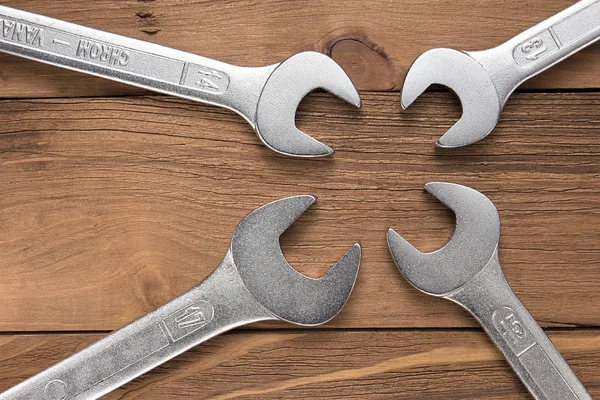 Set of wrenches. Wrenches in several different sizes on natural wooden background. — Stock Photo, Image