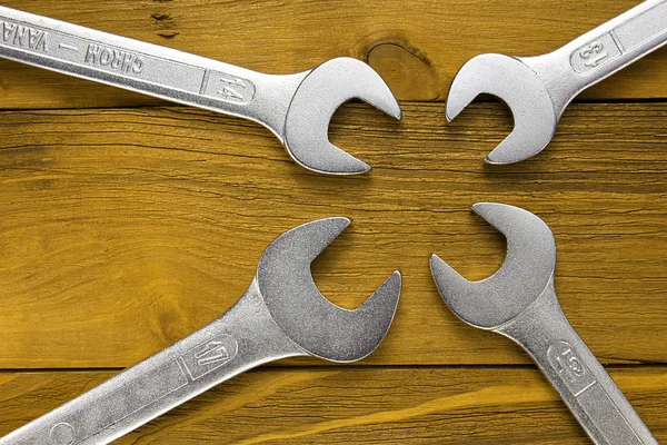 Set of wrenches. Wrenches in several different sizes on natural wooden background. — Stock Photo, Image