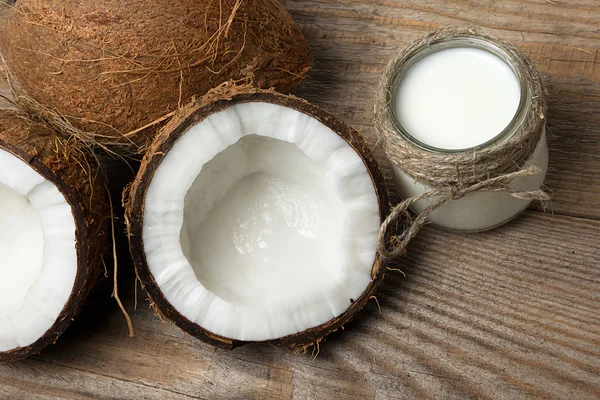 Cocos exóticos, mantequilla de coco y leche sobre fondo de madera. Concepto de alimentos orgánicos saludables. Concepto de belleza y SPA . —  Fotos de Stock