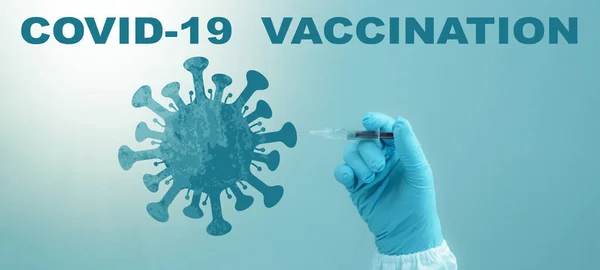 CORONAVIRUS - CORONA VACCINATION STOP COVID-19 - Doctor with syringe in hand injects Corona vaccine into a virus symbol, isolated on blue background