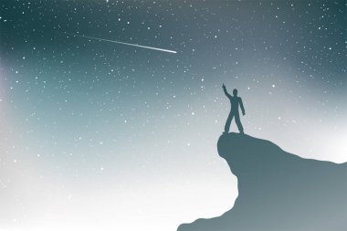 Dağda kayan yıldızları izleyen bir adam.