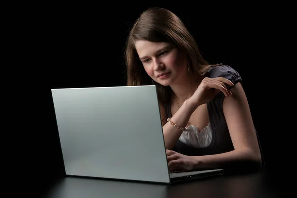 Młoda Dziewczyna Długimi Brązowymi Włosami Laptopa Czarnym Tle — Zdjęcie stockowe