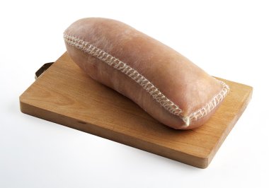 Cotechino Sausage with Rind on cutting board clipart