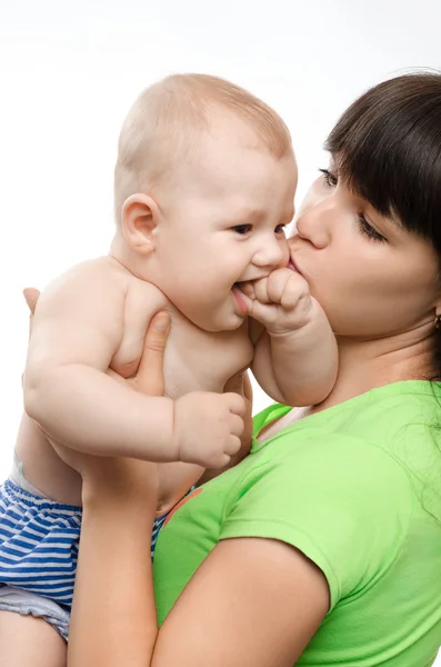 Young mother kissing her little children — Stock Photo, Image