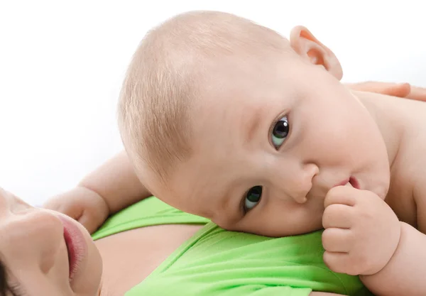 Baby is in its mother's breast and sucks her finger — Stock Photo, Image