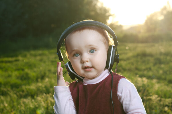 child listening to music on headphones