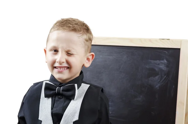 Schoolboy winks at the blackboard — Stock Photo, Image