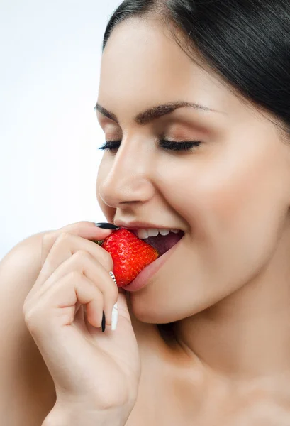 Sexy girl eating strawberries Stock Image