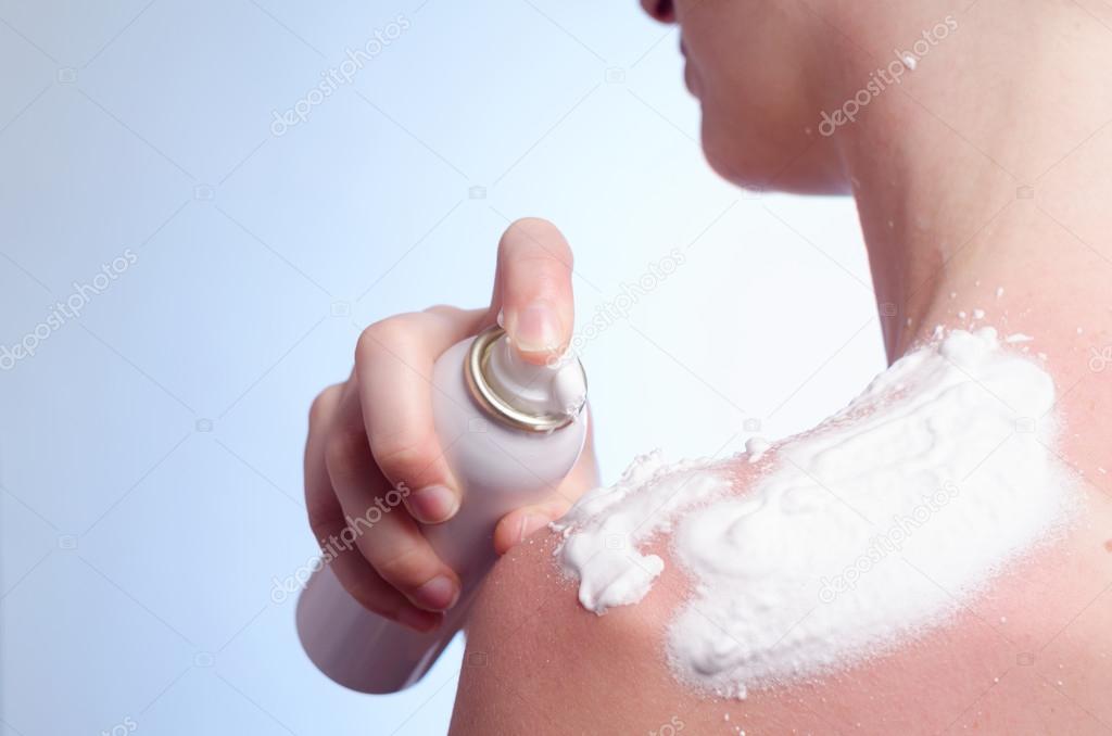 young woman applies cream on the burned skin 