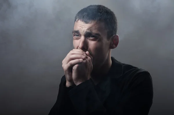 Young man suffocating in the poisonous smoke — Stock Photo, Image