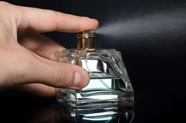 Men's perfume bottle on a black background — Stock Photo, Image