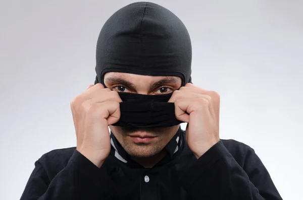 Thief removes the mask — Stock Photo, Image
