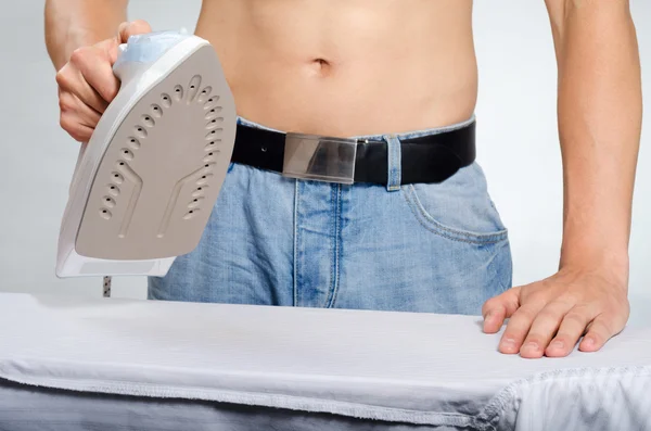 Man ironing a shirt — Stock Photo, Image