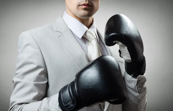 businessman in boxing gloves, ready to fight