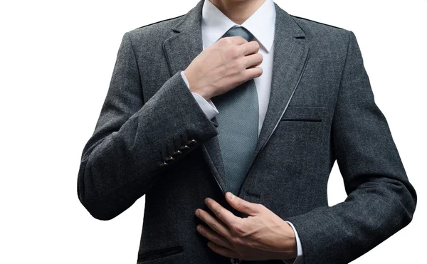 Man in a suit straightens his tie — Stock Photo, Image