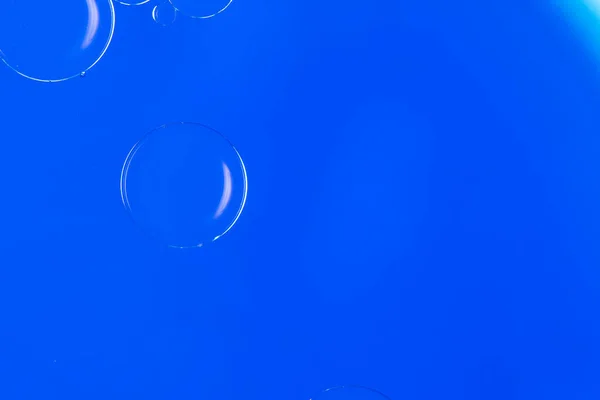 Abstract Macro Photography of a bubble on a blue colour water mixed with blue food color mix. Macro bubble photography.