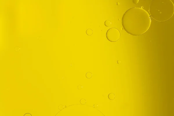 Abstract Macro Photography of a bubble on a yellow colour water mixed with yellow food color mix. Macro bubble photography with empty space available