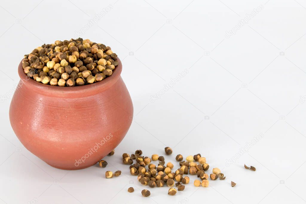 Selective focused Indian health snack called Varuth uppu kadalai , rosted chickpeas with salt on a isolated white background. Rosted without oil and very healthy daily snacks, Tamilnadu, Mumbai, Delhi, Kerala