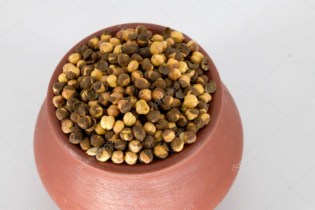 Selective focused Indian health snack called Varuth kadalai , rosted peanuts with salt on an isolated white background. Roasted without oil and very healthy daily snacks, Tamilnadu, Mumbai, Delhi, Kerala