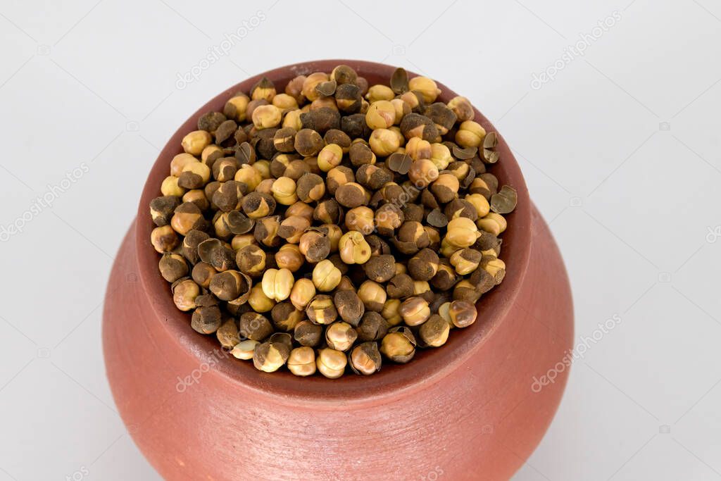 Selective focused Indian health snack called Varuth kadalai , rosted peanuts with salt on an isolated white background. Roasted without oil and very healthy daily snacks, Tamilnadu, Mumbai, Delhi, Kerala