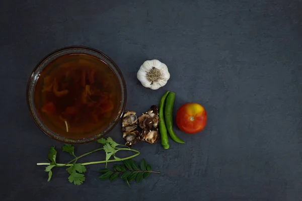 Black pepper and Tomato rasam or clear soup in Indian style, South Indian food recipe called Rasam .  Medicine for coughing, running nose and flu. Rasam in isolated white background with ingredien