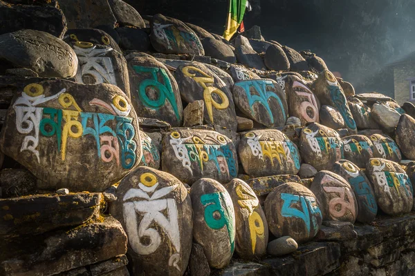 Stones with colorful nepalese characters — Stock Photo, Image