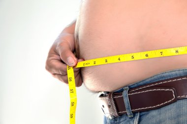 Obese person measuring his belly. clipart