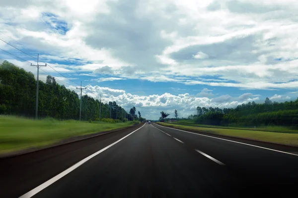 Asphalt road and sky in thThailand with motion blur — стоковое фото